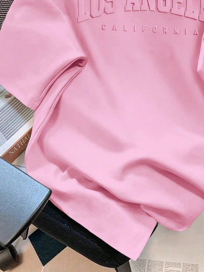 EZwear Plus Size Casual Minimalist Pink English Text Embossed Pattern Round Neck Short Sleeve Loose Fit Plus Size T-Shirt